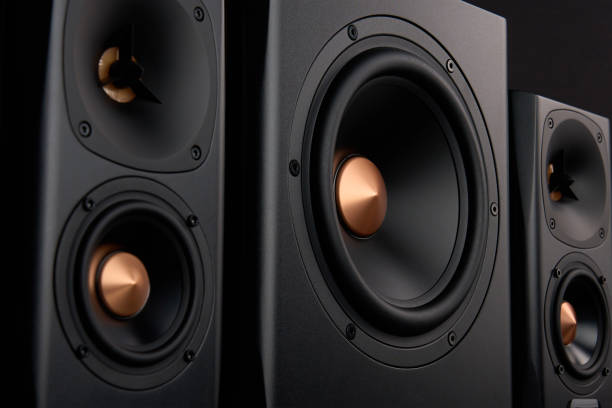 istock Sound audio system with two satellites and subwoofer on dark background. 1567997922