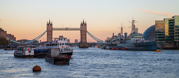 London, United Kingdom - April 25, 2019: River Thames panoramic photo. London city view with Tower Bridge in the evening