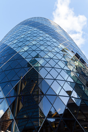 London, United Kingdom - April 25, 2019: Exterior of 30 St Mary Axe previously known as the Swiss Re Building and informally known as the Gherkin. Street view