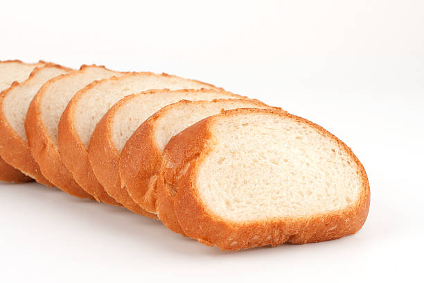 istock Long loaf sliced bread. Isolated on white 156805373