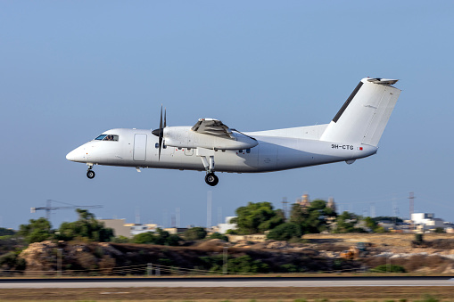 Luqa, Malta - July 24, 2023: Universal Air Bombardier Dash 8-102 (Reg: 9H-CTG) on short finals runway 31.