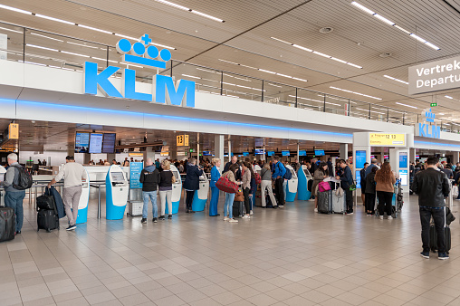 Amsterdam, Netherlands - October 18, 2017: International Amsterdam Airport Schiphol Interior with Passengers. KLM Check-in Zone with People. Netherlands
