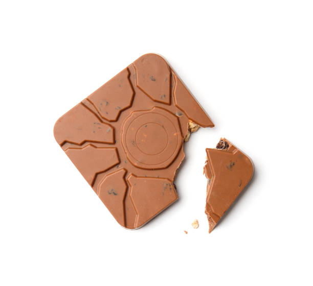 istock Square shaped chocolate with a broken corner on a white background, flat lay, top view. 1568106184
