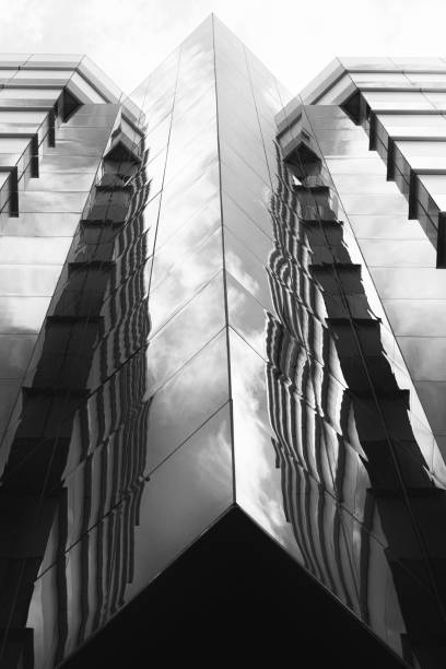 istock View from below of a modern building reflecting the sky 1568107367