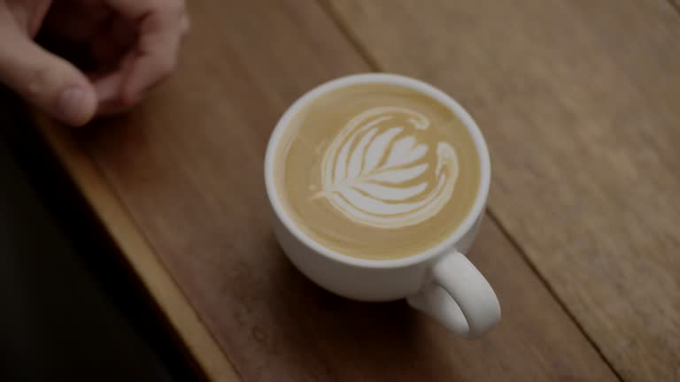 Barista making latte art at a cafe