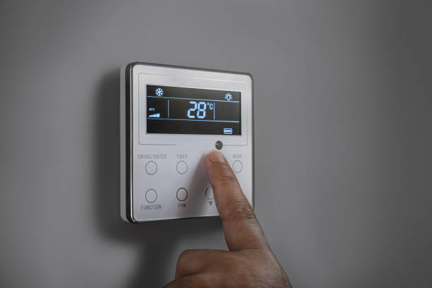 istock A hand adjusting the thermostat temperature. 1568151634