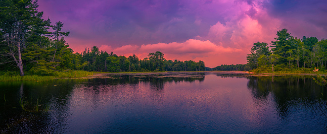 Vibrant saturated stormy sunset landscape at Knickercane Island Park over Back River in Boothbay, Lincoln County, Maine