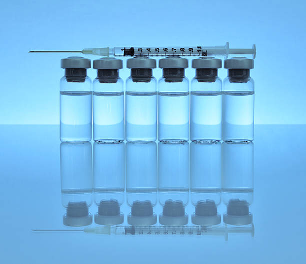 istock Vials of medications with syringe and needle. 156817658