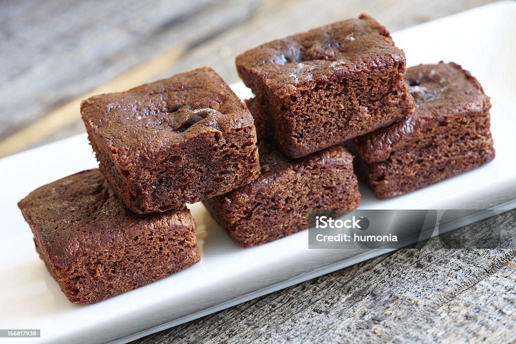 Brownies Little soft chocolate brownies with white meringue on top served in elegant style. Baked Stock Photo