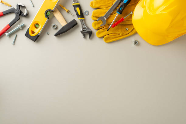 istock Paying homage to construction professionals on Labor Day: overhead composition highlighting construction gear and tools against light grey backdrop. Great for Labor Day-themed advertisements or text 1568181176
