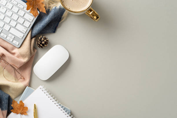 istock Fall vibes while working online with top view photo featuring notepad, pen, glasses, keyboard, mouse, hot coffee, patchy scarf and maple leaves on grey isolated background perfect for text or adverts 1568181601