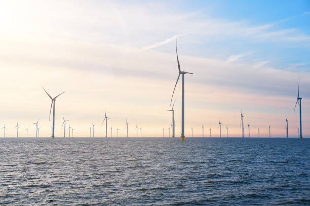 Offshore Windmill farm. windmills isolated at sea on a beautiful bright day Netherlands