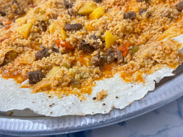 istock Bulgur (bulghur) pilaf with meat and potatoes on the turkish yufka bread (a kind of thin tortilla which made in tandoori) 1568192988