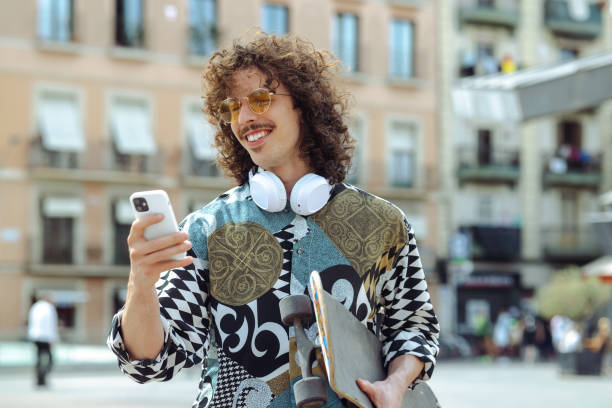 Young Spanish man cheerfully checking his phone