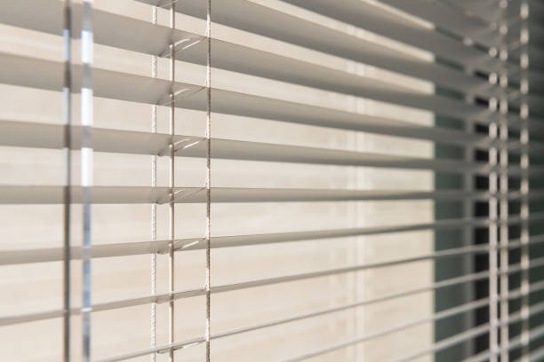 istock Early Morning Sunlight Through Office Window Blinds 1568215776