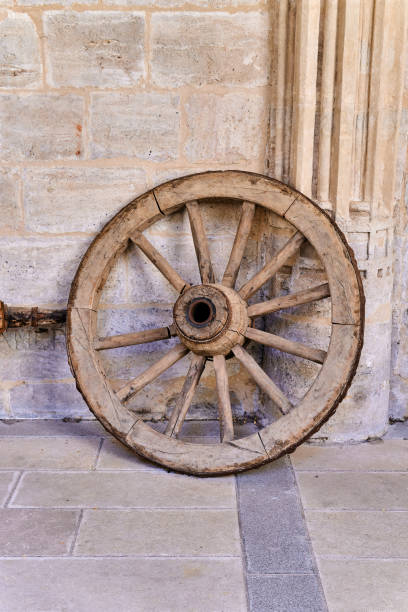 istock Ancient wooden wheel, used by carts intended for monastery construction 1568222069
