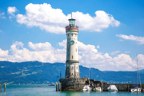 istock Old lighthouse with clock in bay. Antique bavarian town at Lake Constance Bodensee 1568266622