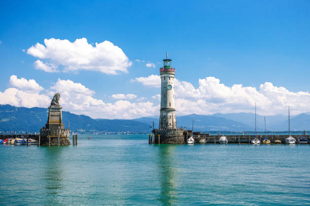 istock Old lighthouse with clock in bay. bavarian town at Lake Constance Bodensee 1568266946