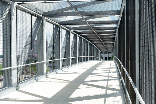 This is a photograph of the interior of a pedestrian bridge in downtown Orlando, Florida on a sunny day.