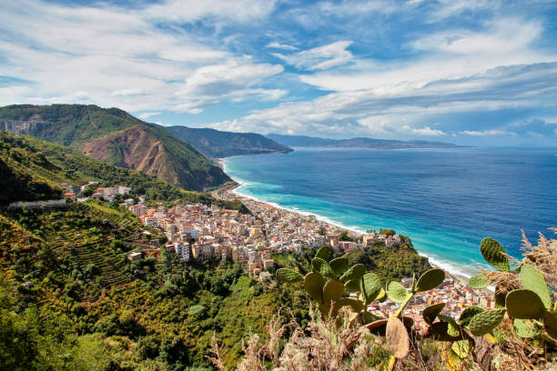 view over the italian city bagnara calabra located directly by the sea in calabria, italy. sicily in the distance - calabria – i̇talya stok fotoğraflar ve resimler