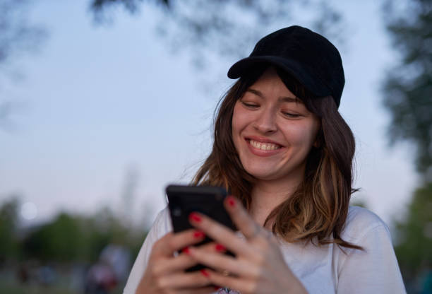 istock happy young lady using mobile phone 1568312960