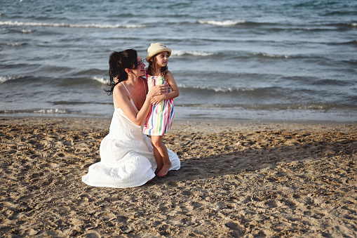 mother with daughter spending the day at the beach.