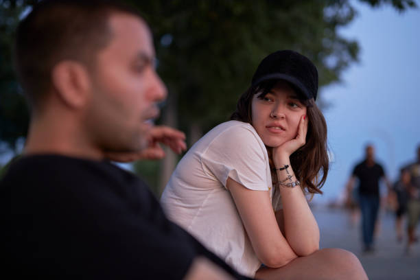 istock young couple talking over a park bench 1568318779