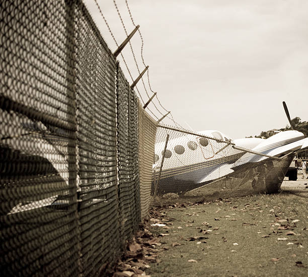 small plane crashes through fence in emergency landing small plane crashes through fence in emergency landing airplane crash stock pictures, royalty-free photos & images