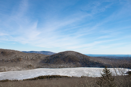 Mirror Lake and a small unnamed mountain on a sunny winter day. Located in Rockport, Maine.