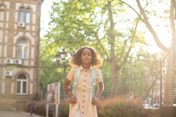 istock Happy school girl with a backpack 1568433287