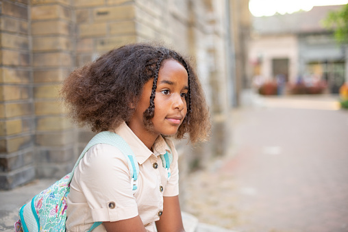 Portrait of a cute girl with a backpack going to school