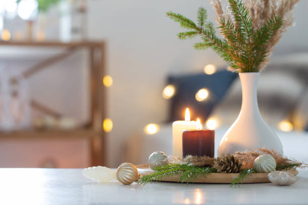 istock burning candles with christmas decor in white cozy interior 1568446848