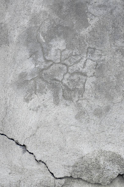 istock Grunge gray natural concrete wall stucco texture, grey rustic plaster macro closeup, old aged detailed rough cracked textured  blank empty copy space background, vertical grungy weathered stained plastered vintage pattern coarse detail 1568446960