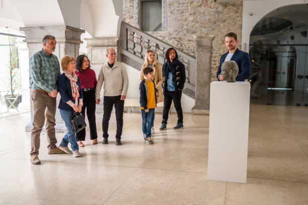istock Mid Adult Museum Guide With Group 1568455310