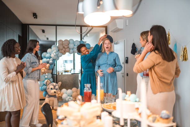 Pregnant woman celebrating baby shower party with friends.