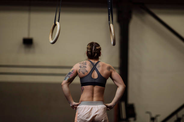 Girl with tattoos in the gym stock photo