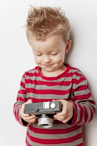 Small boy holding a camera