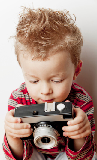 A lovely small boy is making a photo.