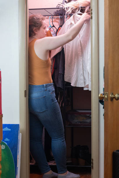 istock Woman Hanging Clothes 1568510351