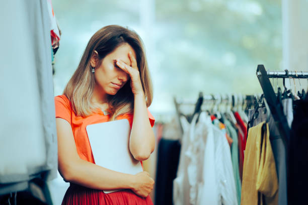 istock Unhappy Store manager Holding a PC Tablet feeling Depressed 1568520090