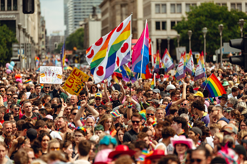 Berlin, Germany, Europe - July 22, 2023:  big crowd of people. People with rainbow symbols on Christopher Street Day In Berlin, CSD 2023. LGBTQIA+ pride in Germany.