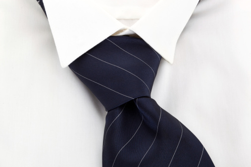 White dress shirt and blue striped necktie. Executive corporate fashion concept.
