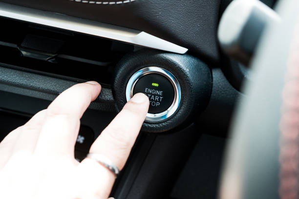 istock Owner finger to touching and press button function start and stop car engine in the automobile. 1568562024
