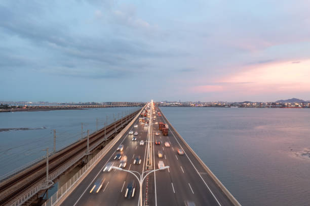 istock Blurred image of traffic flow on cross-sea expressway 1568599498