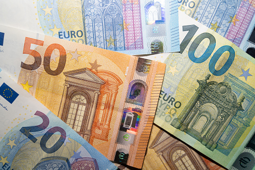 Benjamin Franklin peeking through  50 euro banknotes for design purpose