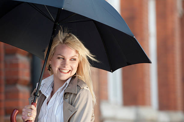 istock Young Woman Smiling with Umbrella 156864667