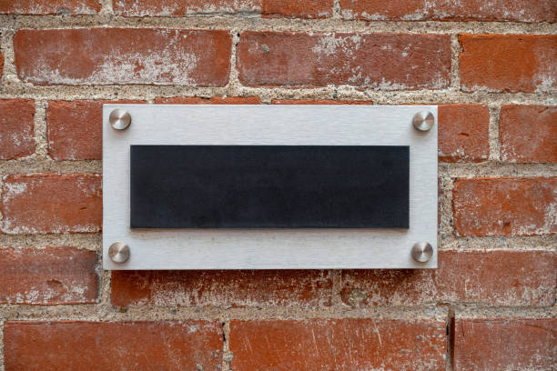 istock Blank metal sign on a brick wall 1568669369