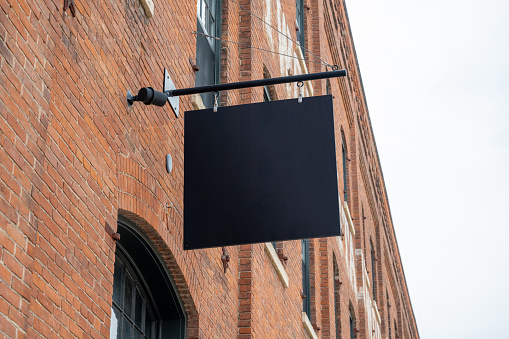 Blank sign on a brick wall for mock-ups