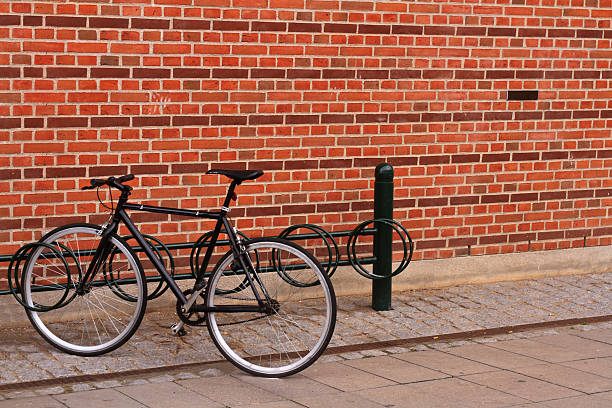 istock Bicycle stands near red brick wall 156868725