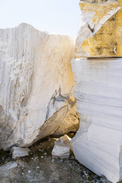 istock marble quarry. Large white marble blocks in an old abandoned quarry. Beautiful marble texture. Smooth cuts at the stones. Large boulder of white marble. 1568697450